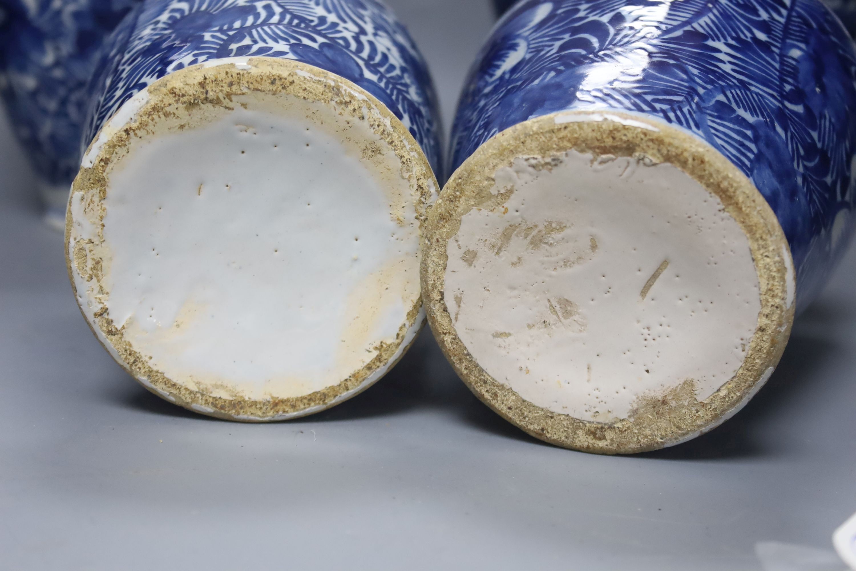 A pair of 18th century Dutch Delft blue and white oviform vases with floral decoration and two similar smaller vases, H 25cm & 19cm